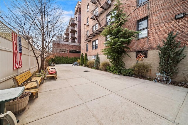 surrounding community featuring a patio and fence