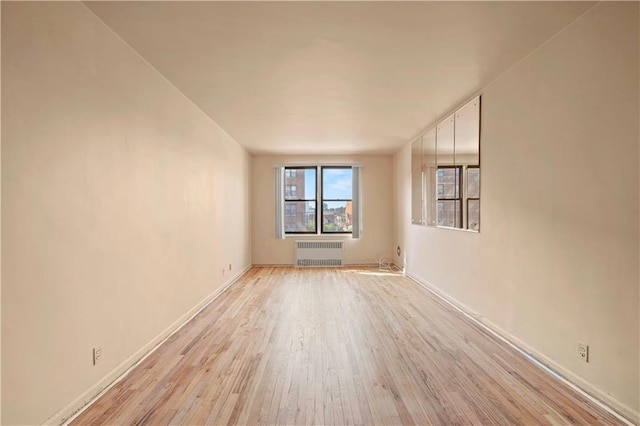 3025 Ocean Ave Unit 4D, Sheepshead Bay, NY 11235 - unfurnished room with radiator heating unit, light wood finished floors, and baseboards