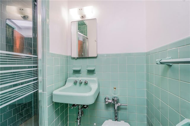 2121 Kimball St, Brooklyn, NY 11234 - bathroom featuring tile walls, a stall shower, a sink, and wainscoting