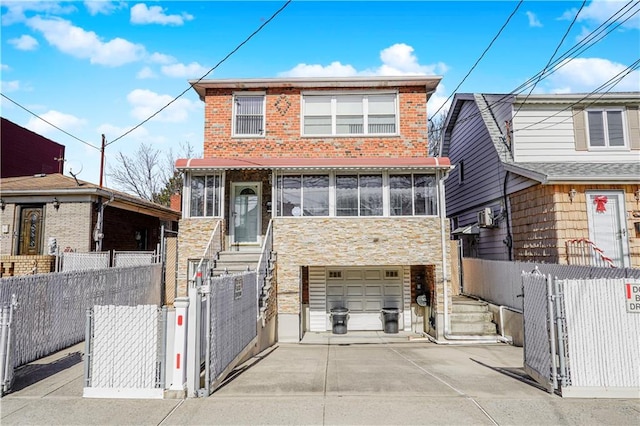 2121 Kimball St, Brooklyn, NY 11234 - view of front facade featuring a gate, concrete driveway, stone siding, a garage, and entry steps