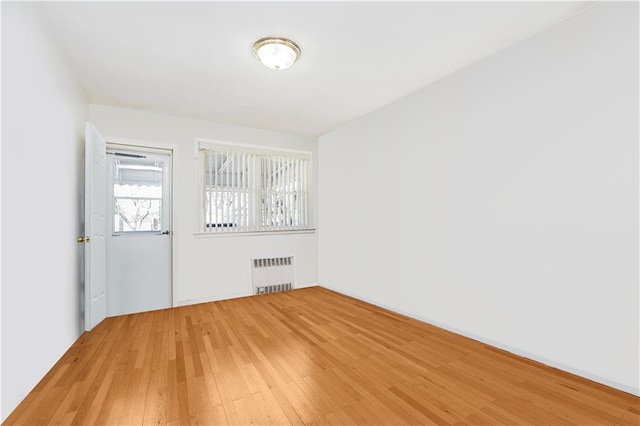2121 Kimball St, Brooklyn, NY 11234 - unfurnished room featuring radiator and light wood finished floors