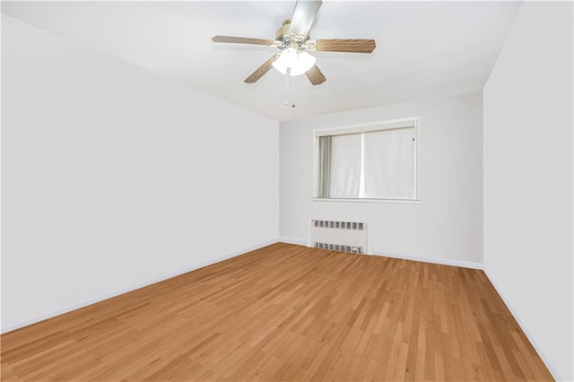 2121 Kimball St, Brooklyn, NY 11234 - empty room with radiator heating unit, light wood finished floors, baseboards, and ceiling fan