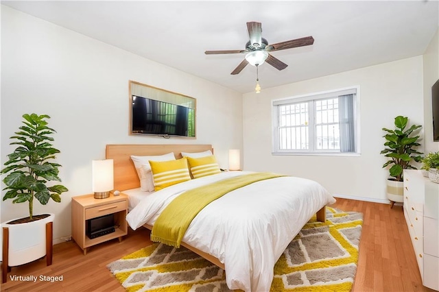 bedroom featuring light wood-type flooring and baseboards