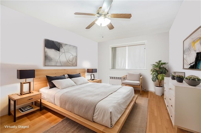 2121 Kimball St, Brooklyn, NY 11234 - bedroom featuring radiator, light wood-style flooring, and ceiling fan