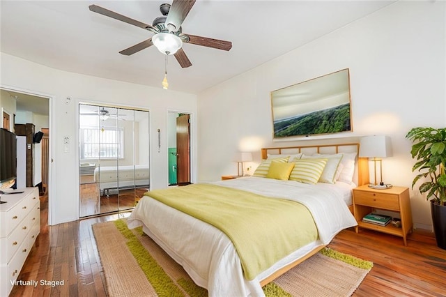 bedroom with hardwood / wood-style floors, a closet, and a ceiling fan