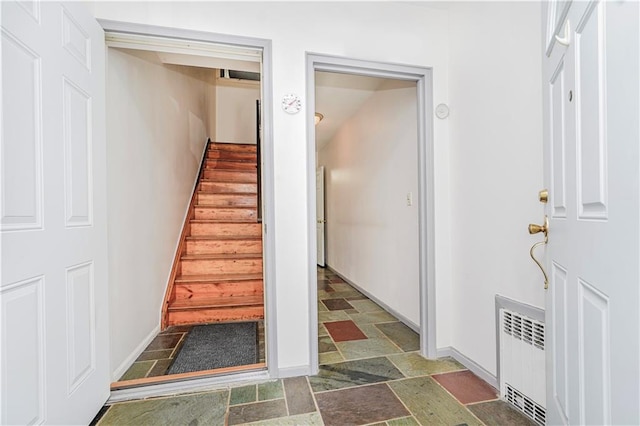 2121 Kimball St, Brooklyn, NY 11234 - stairs featuring radiator heating unit, stone finish floors, and baseboards