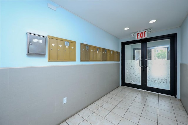 8895 26th Ave Unit 4A, Brooklyn, NY 11214 - doorway to outside with french doors, mail area, and wainscoting