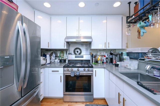 8895 26th Ave Unit 4A, Brooklyn, NY 11214 - kitchen with appliances with stainless steel finishes, under cabinet range hood, white cabinetry, light countertops, and recessed lighting