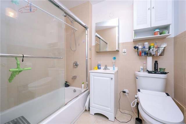 8895 26th Ave Unit 4A, Brooklyn, NY 11214 - full bathroom featuring toilet, bath / shower combo with glass door, vanity, and tile walls