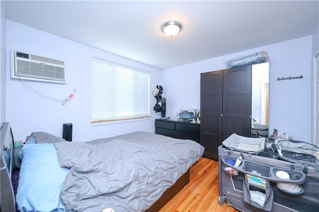 8895 26th Ave Unit 4A, Brooklyn, NY 11214 - bedroom featuring light wood-style flooring and an AC wall unit