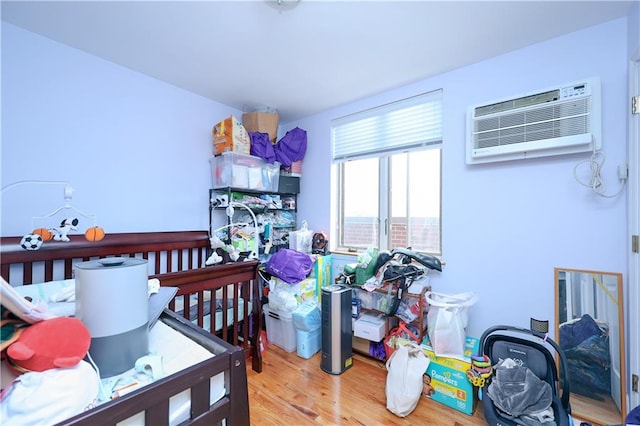 8895 26th Ave Unit 4A, Brooklyn, NY 11214 - bedroom with a wall mounted air conditioner and wood finished floors