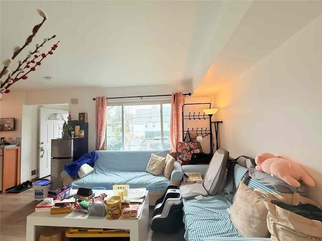 living area featuring carpet floors and lofted ceiling
