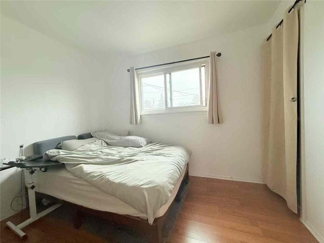 bedroom with wood finished floors