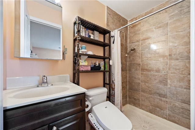 bathroom featuring tiled shower, toilet, and vanity