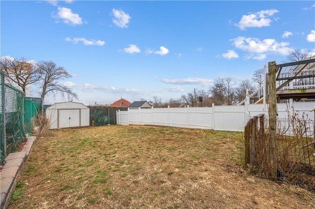 view of yard with a storage unit, an outdoor structure, and a fenced backyard