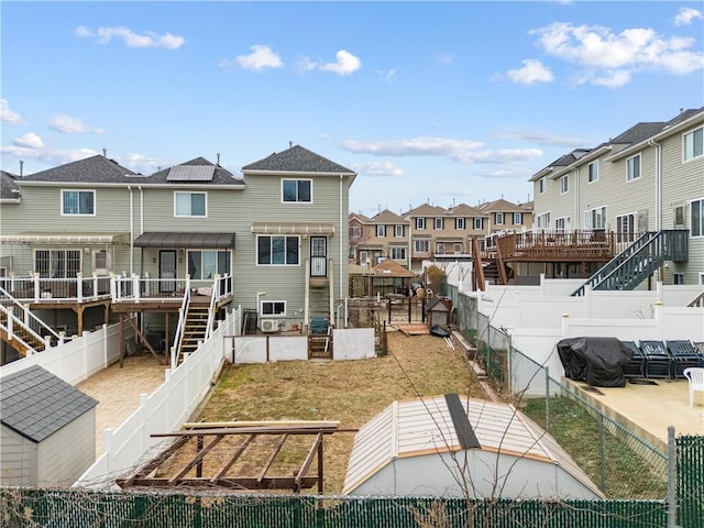 exterior space featuring a fenced backyard, a residential view, and stairs