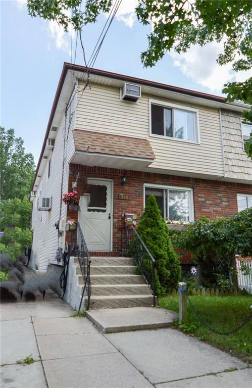 townhome / multi-family property featuring brick siding and a wall mounted AC