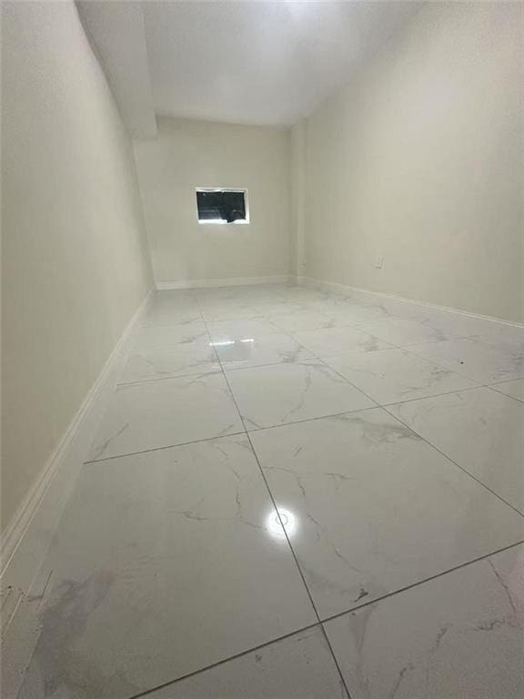 19 Drumgoole Rd, Staten Island, NY 10312 - empty room with light marble finish flooring and baseboards