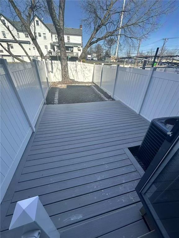 19 Drumgoole Rd, Staten Island, NY 10312 - wooden deck with a fenced backyard and central AC unit