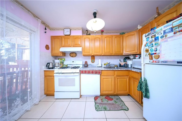 78 Townsend Ave, Staten Island, NY 10304 - kitchen with white appliances, under cabinet range hood, a sink, light countertops, and light tile patterned flooring