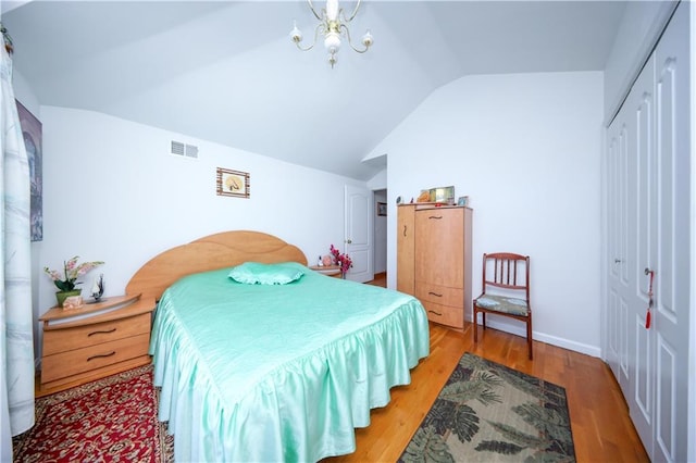 78 Townsend Ave, Staten Island, NY 10304 - bedroom with a closet, lofted ceiling, light wood-type flooring, and a chandelier