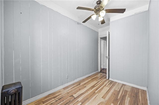 1572 E 34th St, Brooklyn, NY 11234 - spare room featuring light wood-type flooring, radiator, ceiling fan, and baseboards