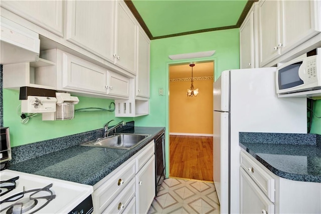 kitchen featuring white cabinets, a sink, dark countertops, white appliances, and open shelves