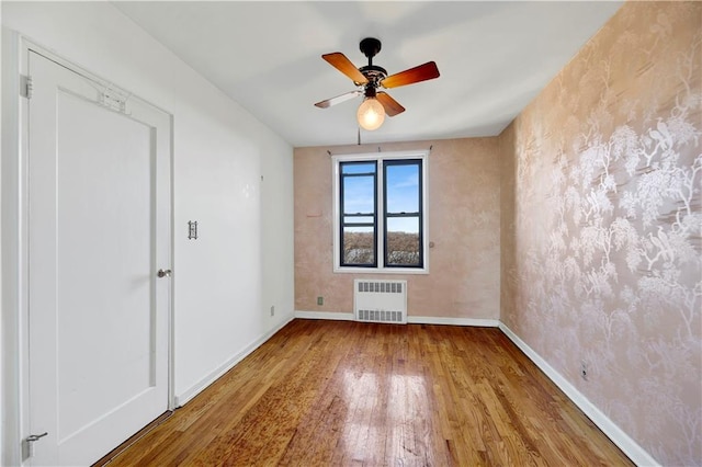 2260 Burnett St Unit 6K, Brooklyn, NY 11229 - spare room featuring radiator, wood finished floors, baseboards, and a ceiling fan