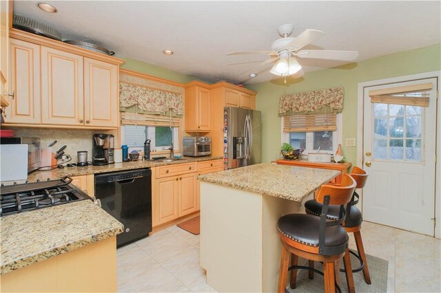 kitchen featuring dishwasher, stainless steel fridge with ice dispenser, light tile patterned floors, a center island, and a breakfast bar area