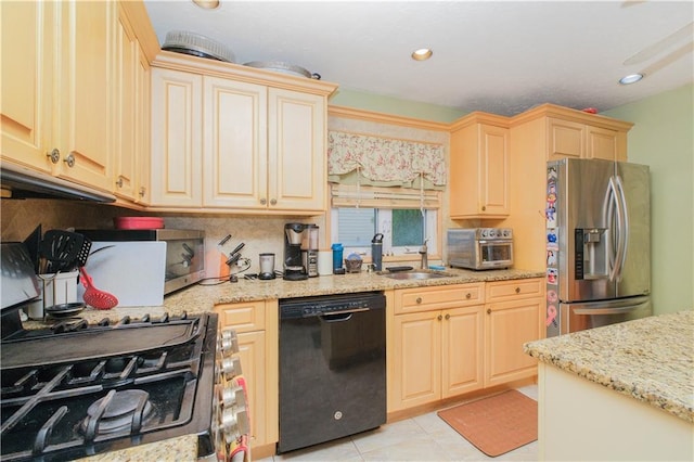 kitchen with black dishwasher, stainless steel refrigerator with ice dispenser, a sink, decorative backsplash, and light stone countertops