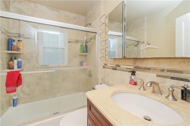bathroom featuring enclosed tub / shower combo, vanity, and toilet