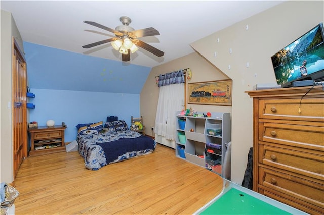 bedroom featuring light wood-type flooring, a ceiling fan, and lofted ceiling