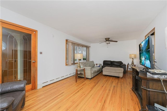 living area with a baseboard radiator, light wood-type flooring, and a ceiling fan
