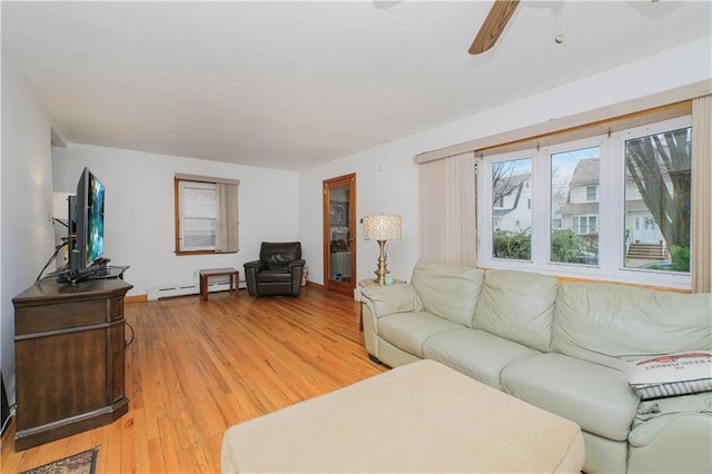 living room featuring baseboard heating, ceiling fan, and light wood-style floors