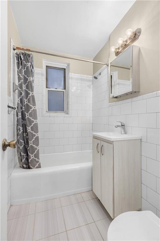 full bathroom with tile walls, shower / tub combo, toilet, vanity, and tile patterned floors