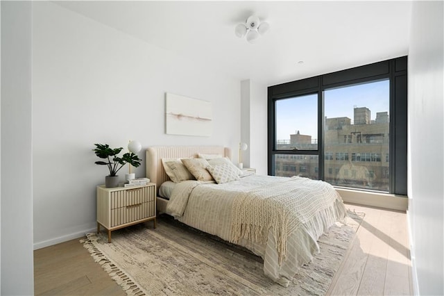 2286 Cropsey Ave Unit 5F, Brooklyn, NY 11214 - bedroom featuring baseboards, wood finished floors, and a view of city
