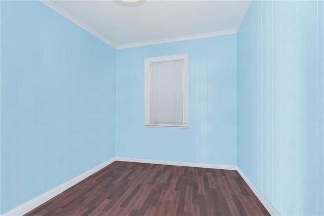 empty room featuring crown molding, baseboards, and dark wood-style flooring