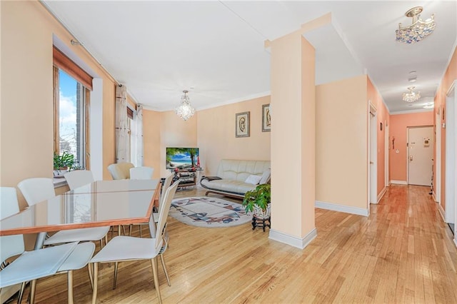 197 Bay 47th St Unit 5, Brooklyn, NY 11214 - dining space with a chandelier, light wood-style flooring, baseboards, and ornamental molding