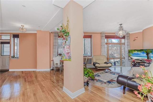 197 Bay 47th St Unit 5, Brooklyn, NY 11214 - living room featuring a chandelier, hardwood / wood-style flooring, baseboards, and crown molding