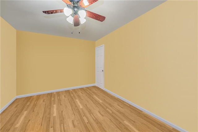 unfurnished room featuring a ceiling fan, baseboards, and light wood-type flooring