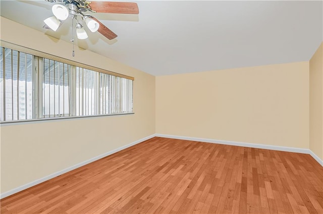 unfurnished room featuring baseboards, light wood finished floors, and ceiling fan