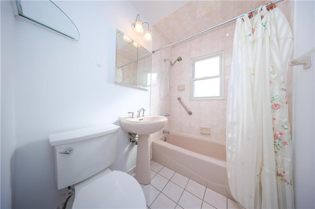 bathroom featuring toilet, tile patterned floors, and shower / tub combo with curtain