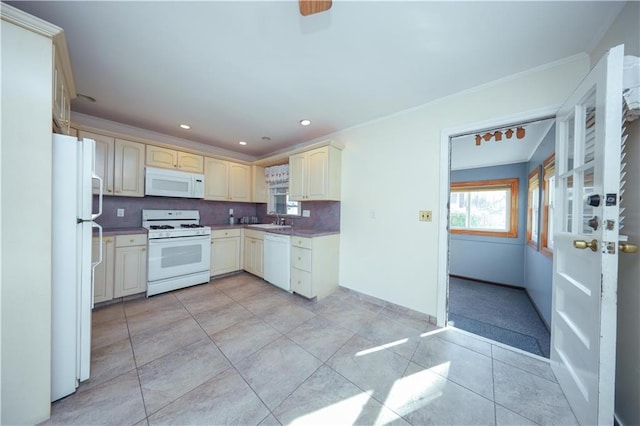 kitchen featuring a sink, ornamental molding, white appliances, cream cabinetry, and recessed lighting