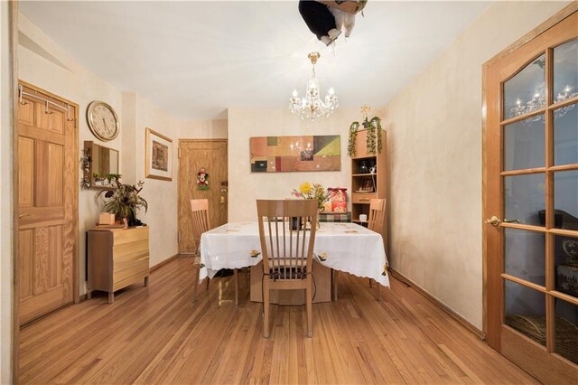 9040 Fort Hamilton Pkwy Unit 3K, Brooklyn, NY 11209 - dining room featuring a chandelier and hardwood / wood-style flooring