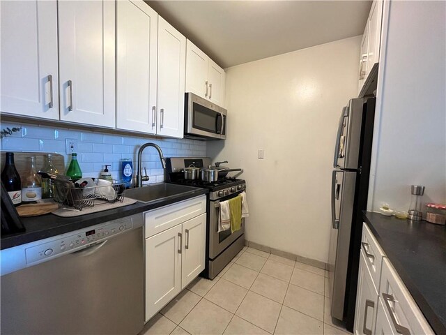 385 Douglass St Unit 3B, Brooklyn, NY 11217 - kitchen with appliances with stainless steel finishes, a sink, dark countertops, and backsplash