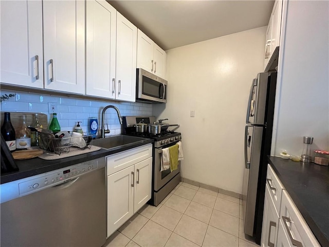 385 Douglass St Unit 3B, Brooklyn, NY 11217 - kitchen with appliances with stainless steel finishes, dark countertops, tasteful backsplash, and white cabinets