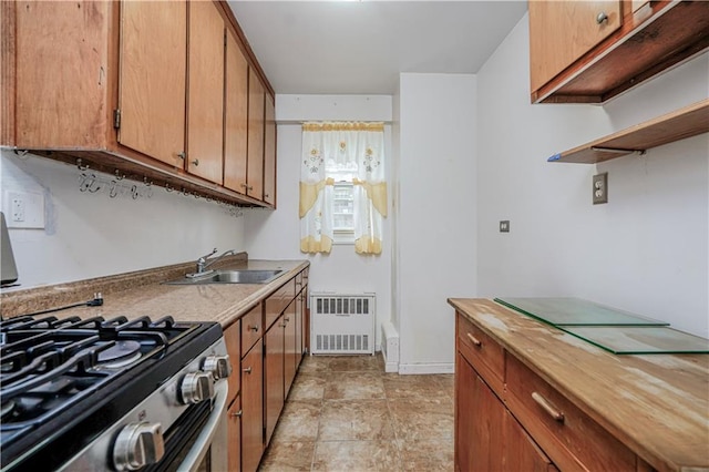 2928 W 5th St Unit 5F, Brooklyn, NY 11224 - kitchen featuring stainless steel gas stove, radiator heating unit, brown cabinetry, and butcher block countertops