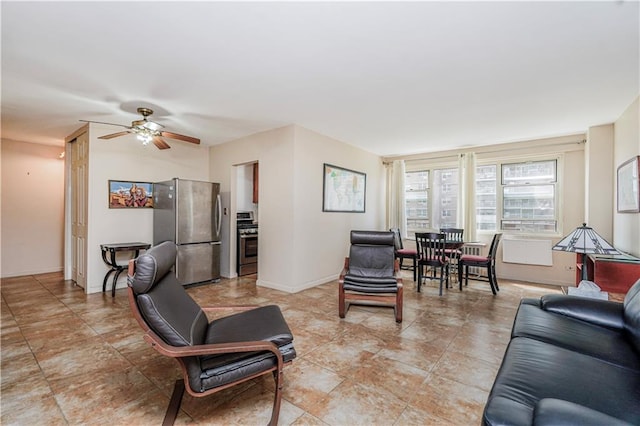 living room with a ceiling fan and baseboards