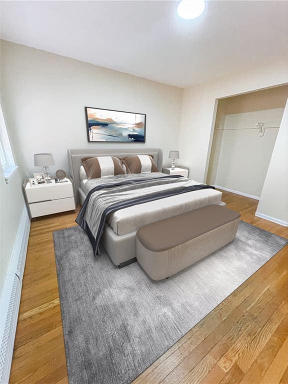 bedroom featuring wood finished floors and baseboards