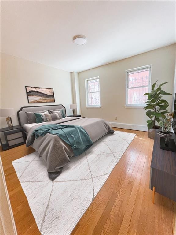 bedroom featuring light wood-style floors and baseboards